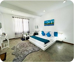 Spacious Bedroom Suite with Plush Lounge and Ocean Breeze